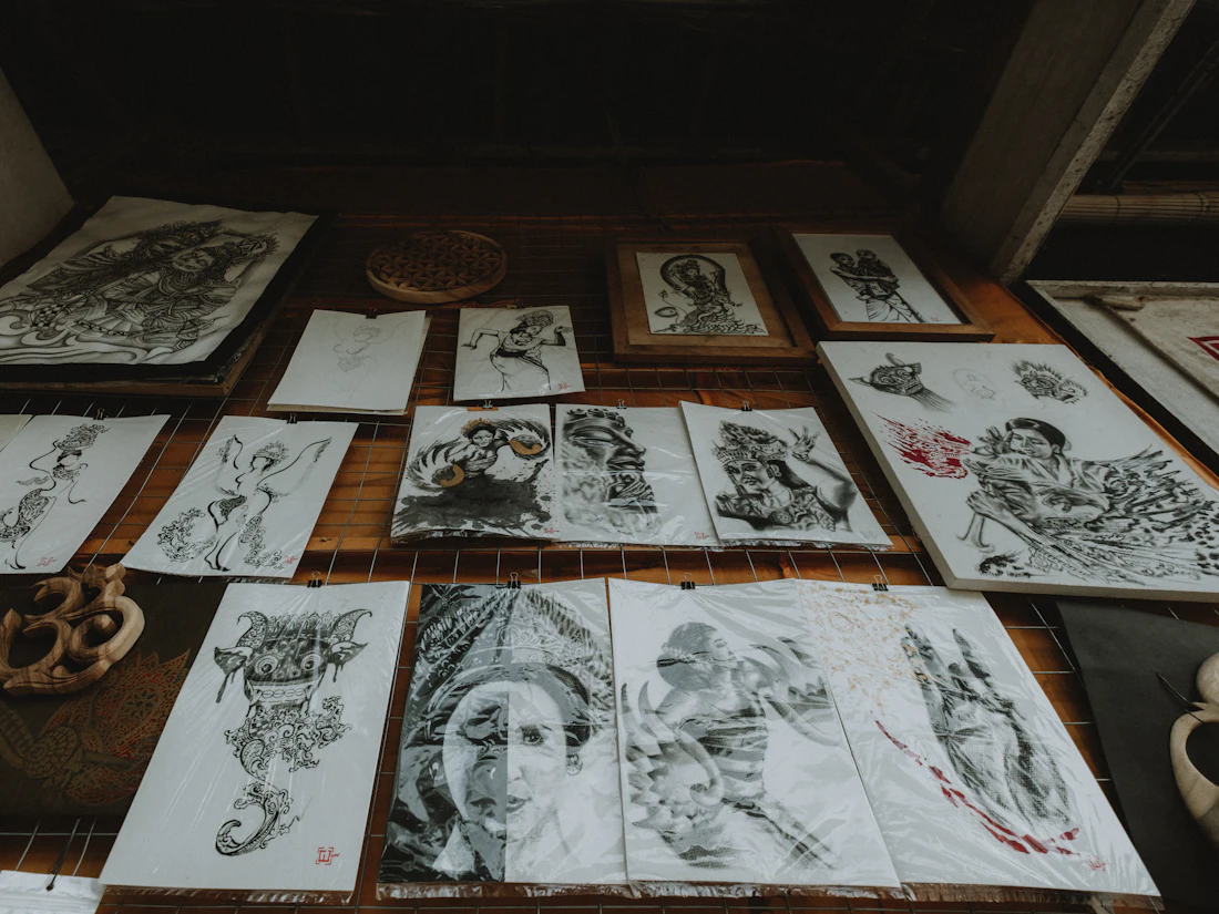 Original tattoo sketches spread across a table